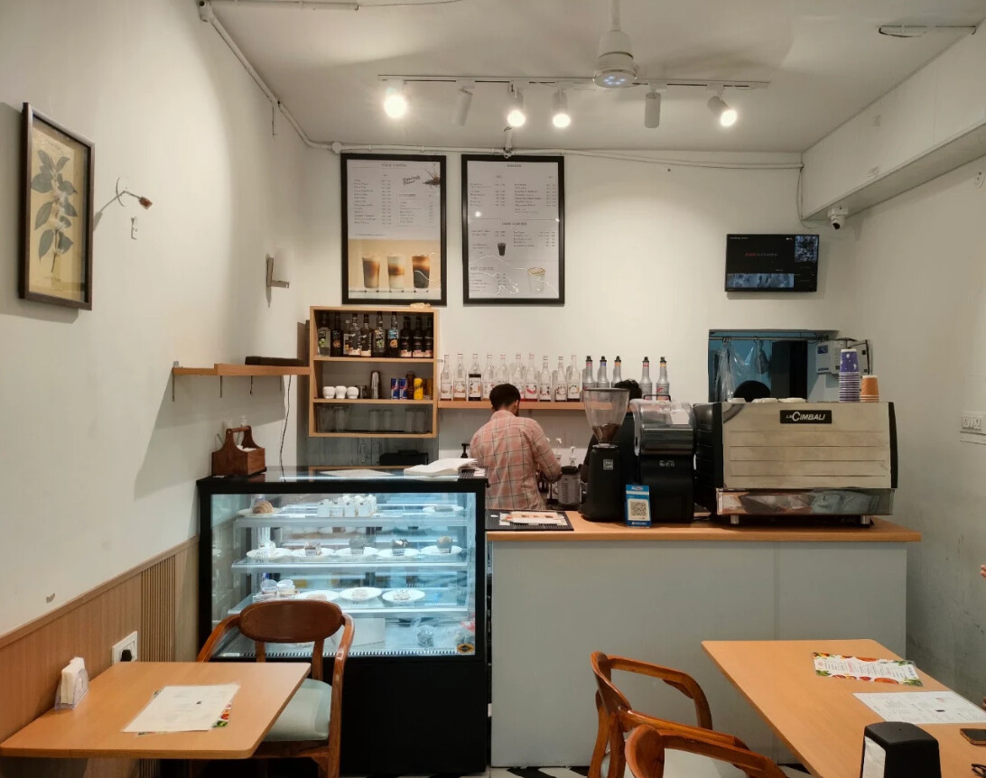 Inside Coffee Heaven — the espresso bar, pastry display and café seating in Model Town, Rewari