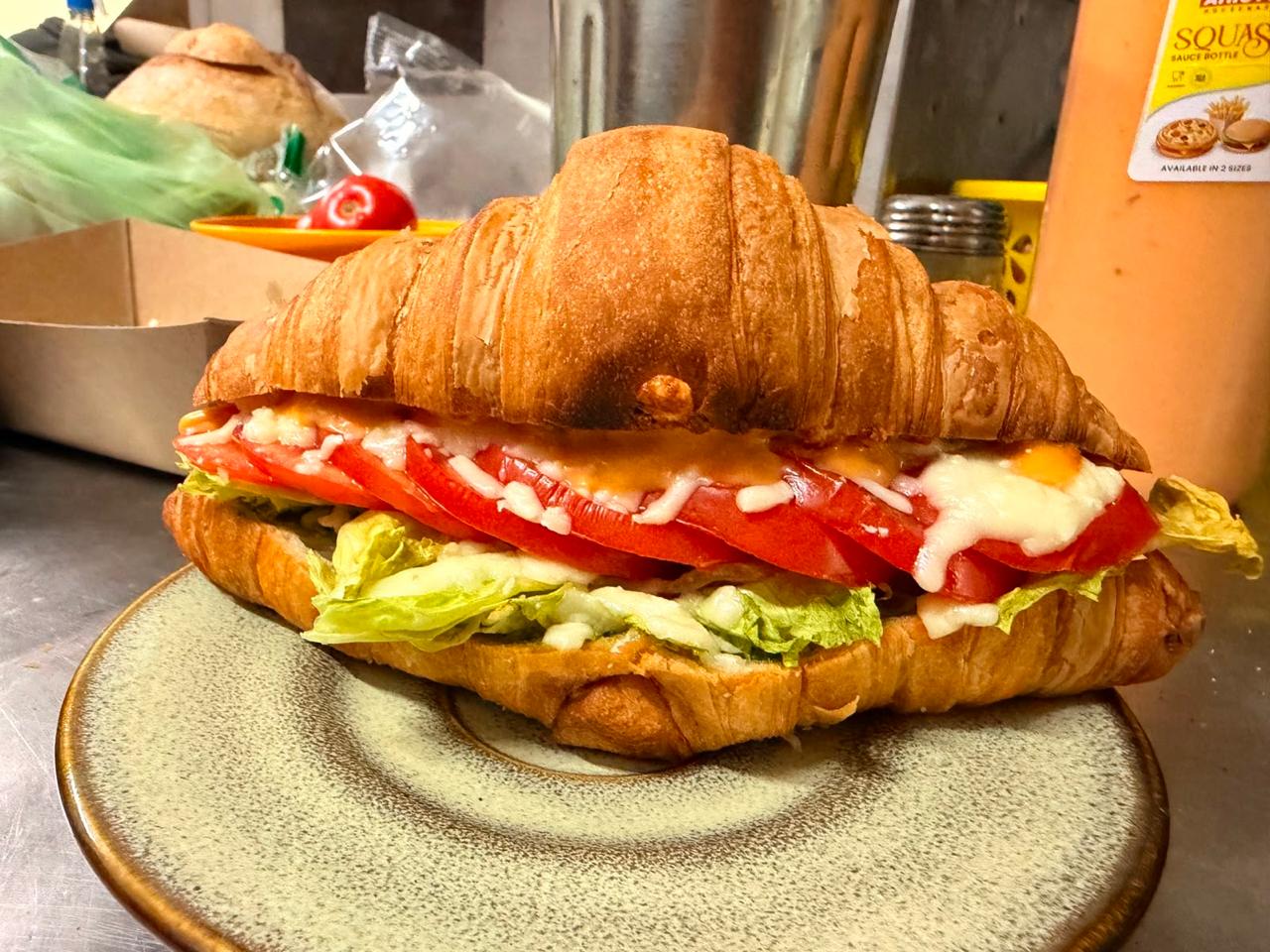 Avocado sandwich served in a flaky croissant