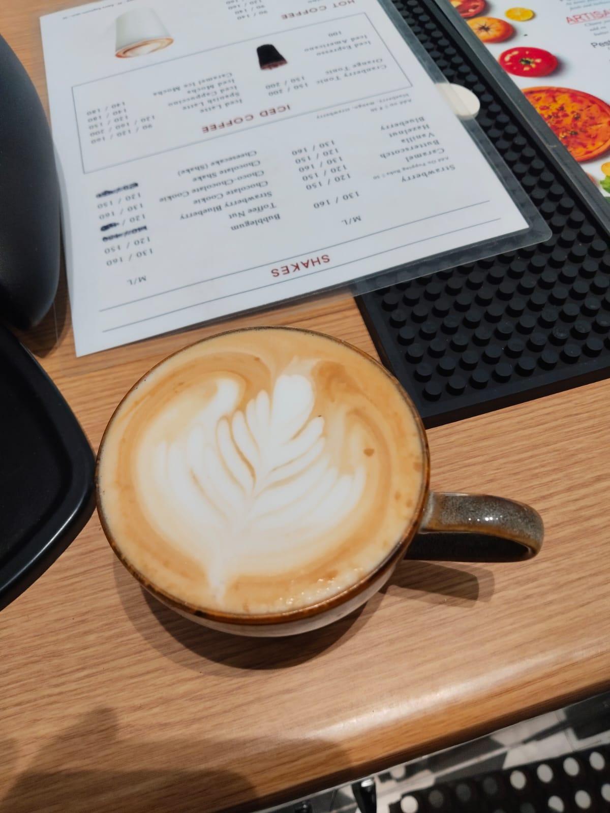 Hot latte with leaf-shaped latte art